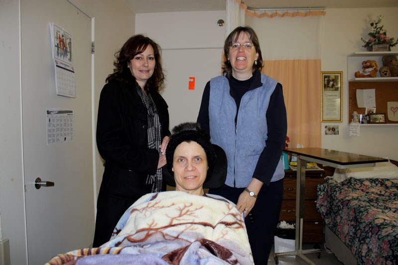 Shelly Beeching (centre) is the recipient of a new wheelchair, partly funded by the MS Society&#8217;s Lakeland regional office. Here, Gail Plouffe, (left) MS client services 