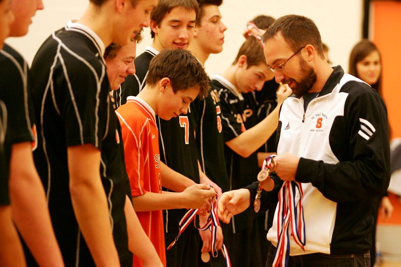 Members of the St. Paul Regional Saints&#8217; boys volleyball team receive their bronze medals during last weekend&#8217;s 2010 Zones Volleyball championship in St. Paul.