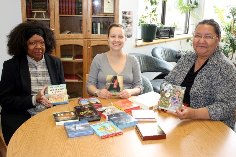Pictured are former library board member Diana Tyler-Moon (left) and library manager Aleta Gaucher (right), who took over the position from Joanne Knysh (centre). After being 