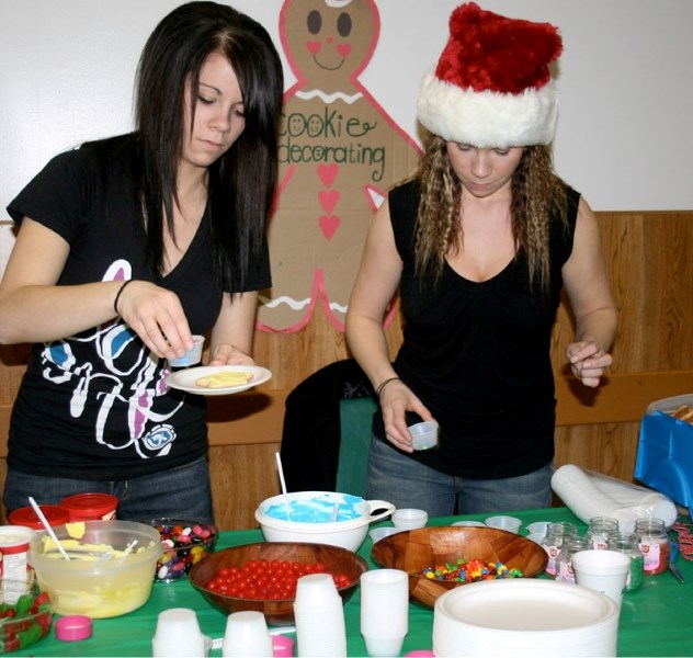 Janelle Hebert and Natalie Hebert were two volunteers that helped kids decorate cookies at the Festival of Hope fundraiser, held in St. Paul on Dec. 5.