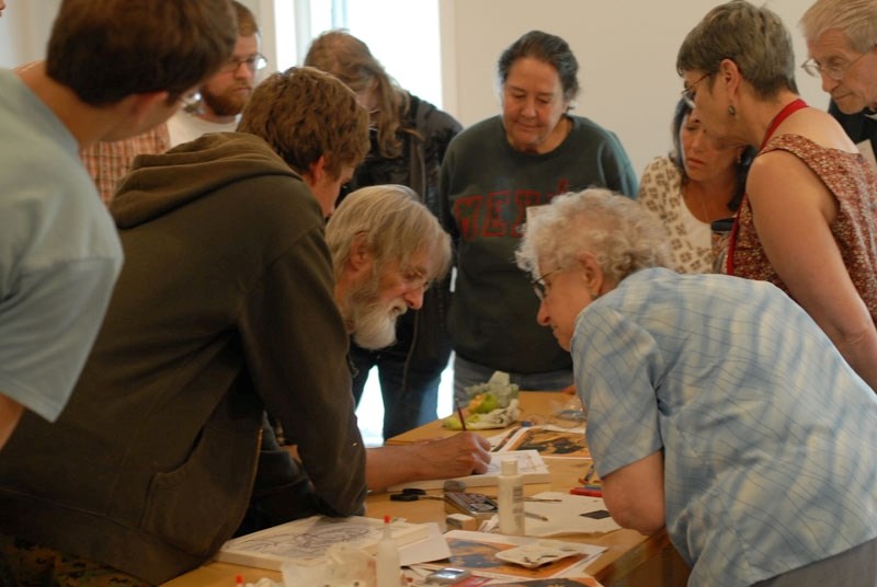 Frank Turner demonstrates proper iconography technique to a group of summer students at Living Water College.