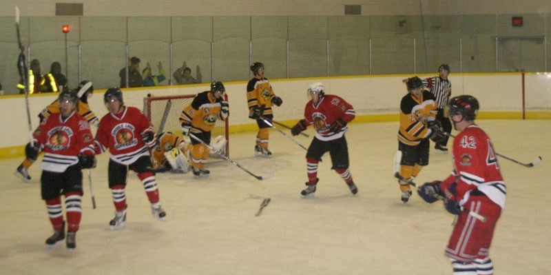 The Warriors celebrate after putting in one of its one five goals in the final period of its Dec. 12 game against the Vermilion Tigers. The Warriors went on to win by 7