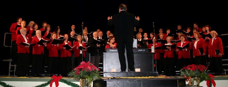 Dixie Coleman directs the Elk Point and District Community Choir in &#8220;River Song&#8221; at Friday&#8217;s concert, with Caitlyn Tazzer and Udo Mueller providing