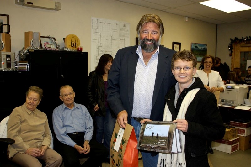 Nicole Brousseau receives congratulations and a small gift from MLA Ray Danyluk for her contributions to the 2011 constituency calendar. Her pictures are displayed on the