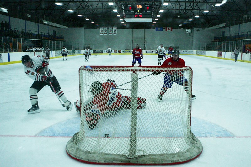 Corey Hunter, from the Saddle Lake Warriors, scores against Carlen Lyle, goalie for the St. Paul Canadiens, during the third period of the Canadiens &#8211; Warriors game on