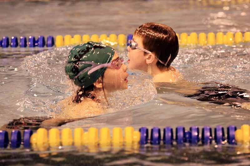 Karlee Seguin (left) and Ben Malo (right) participate in the St. Paul Barracudas Swima-a-thon on Thursday evening.