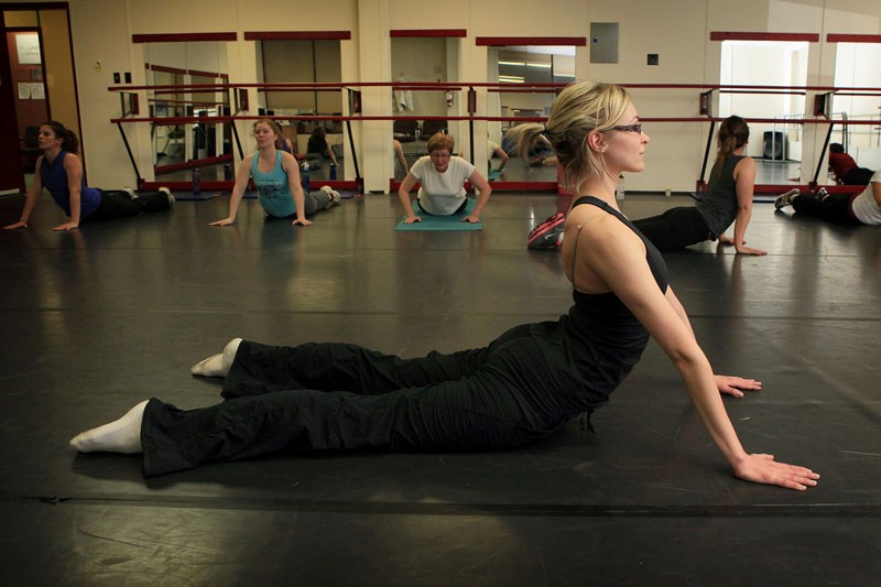 Raven White, a dance instructor at St. Paul&#8217;s Silhouette Dance School, leads her Jazzercise students in stretching exercises at the beginning of last Thursday