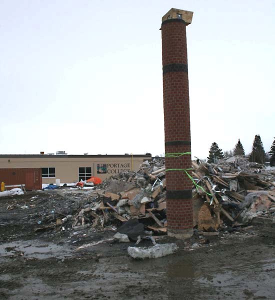 Work crews demolished the remains left of the Portage College residence building last week that was under construction before destroyed by fire.