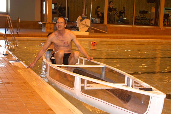 Scott Adamson settles into the glass canoe he invented for a dip test at the St. Paul Aquatic Centre on March 25.
