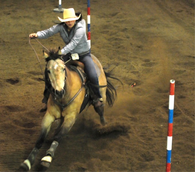 Taylor Smith goes through her run through the poles on Saturday at the Ag Corral.