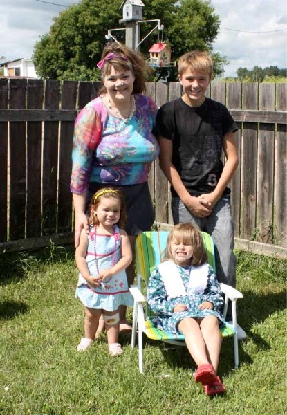 Charissa Miller and her children were enjoying the sunshine in the yard of their home at Sun Country Trailer Park on Sunday afternoon. They are now able to plant flowers and