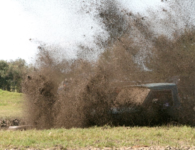 Mud flies as a competitor makes his way thorugh one of the mudbog pits at Glendon Derby Daze on Aug. 13.