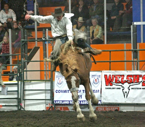 Chad Thomson hangs on for eight as he competes in the saddle bronc event on opening night of the LRA Finals.