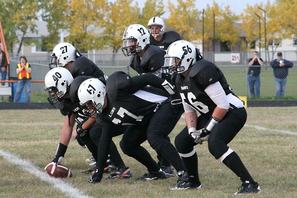 The Lions offensive squad readies for the play against the Commandos on Friday in St. Paul. From left: Zac Smith, Dallas Anderson, Ryan Chrapko, Brendan McKay (QB), Brady