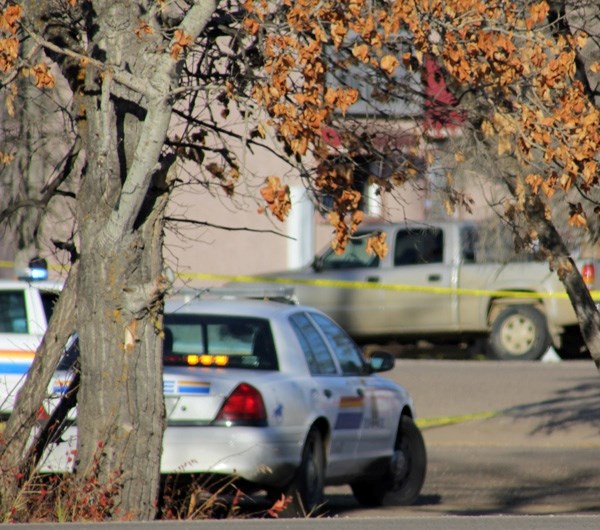RCMP officers investigate the site where a male in his 20s died after an alleged altercation with two males in Glendon on Wednesday morning.