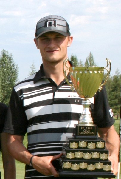Jamie Sadlowski holds the St. Paul Golf Club championship trophy this summer.