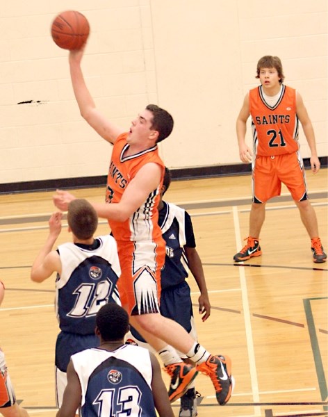 Jonathan Shapka gets air time trying to get a two-pointer for the Saints in the final on Saturday at Regional High School. The Saints boys team advanced to finals but lost to 