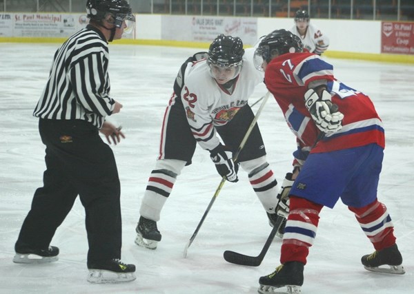 Saddle Lake Warriors Jordan Moosewah (22) faces off against Rylan Couch (27) on Thursday in St. Paul. The Saddle Lake Warriors beat the Habs 8 &#8211; 6.