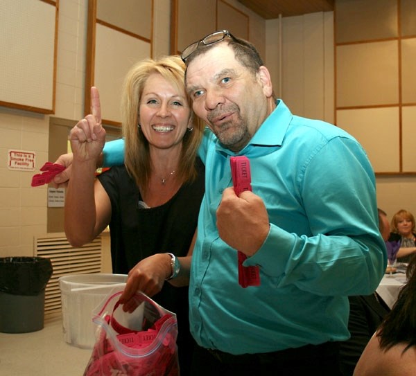 The number one team of Alice Haraba and Leonard Chomlak sell 50/50 tickets to tables at the St. Paul and District Hospital fundraiser on Saturday.