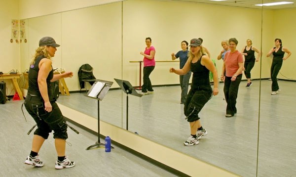 Lori-Anne Peters teaches a Zumba class at the Ukrainian Dance Club Studio in St. Paul. Peters has almost 120 pounds since joining Curves and becoming an instructor.