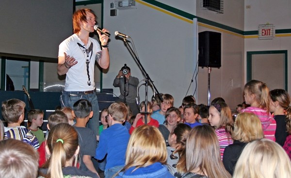 Clayton Bellamy speaks to kids at Glendon School during his presentation, which also featured a video segment with Terry Grant the Mantracker and Jordan Tootoo from the