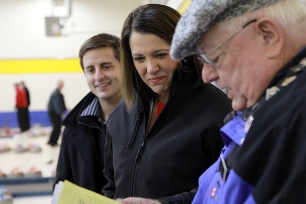 Local Wildrose candidate Shayne Saskiw (left), leader Danielle Smith and bonspiel organizer Paul E. Boisvert talk curling at the Curling Club in St. Paul on March 28.