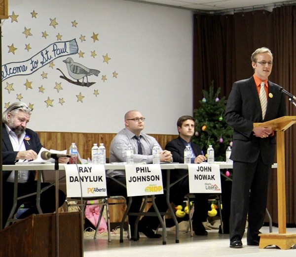 NDP candidate Phil Johnson introduces himself at the all-candidates forum on April 9 at the St. Paul Senior Citizens Centre. Sitting behind him are PC candidate Ray Danyluk