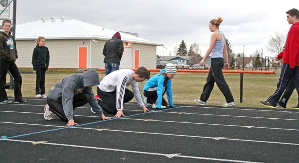 NEAT members (from left) Lindsay MacDonald, Eric Laramee and Nicole Kitt get set to run the 100m at Regional High School in St. Paul last week. The club heads to Calgary this 