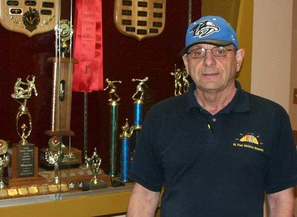 Conrad Jean stands in front of the St. Paul Abilites Network&#8217;s trophy case for their various athletic awards. Jean recently retired, after working at the organization