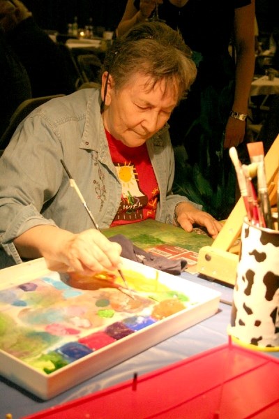 Visual artist Suzanne Jean paints during the live art portion of the Jazz Art event in St. Paul over the weekend. The art was auctioned off later in the evening.