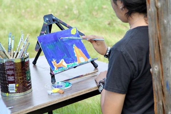 A young painter works on a unique piece at last week&#8217;s cultural camp at Blue Quills.