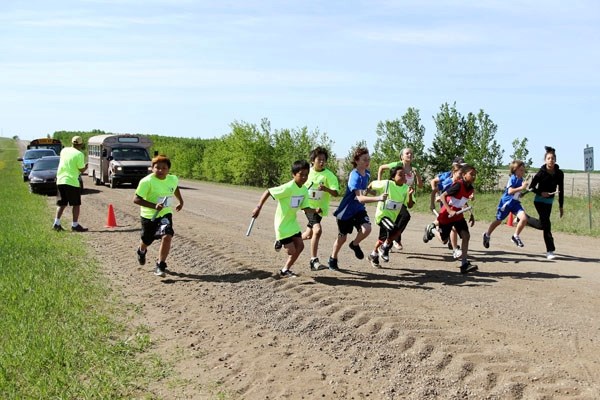 Students taking part in the annual Wind Runners Invitational, hosted by Onchaminahos School, take off at the start of the race, held on June 1.
