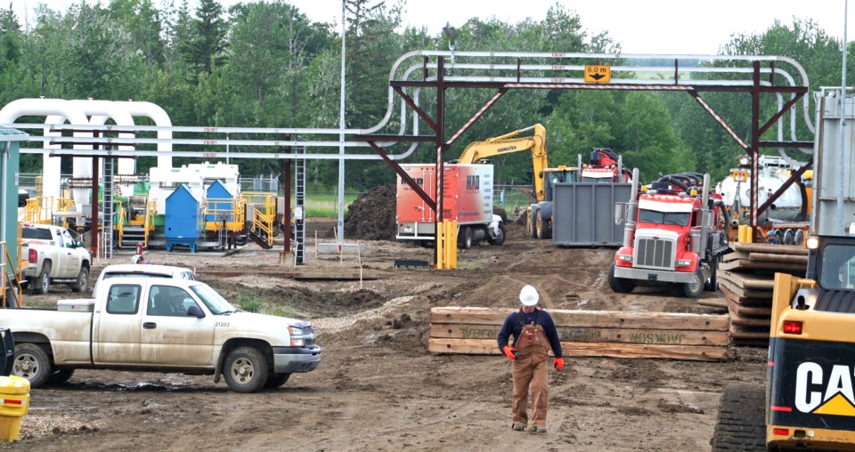 Workers clean up the oil spill at an Enbridge oil pumping station south of Elk Point.