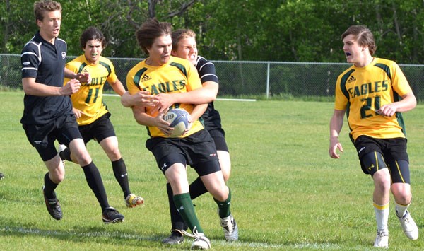 H.A. Kostash/Vilna School&#8217;s Ruan Raubenheimer prepares to pass the ball to teammate Aaron Frick during the provincial rugby tournament in Edmonton earlier this month.