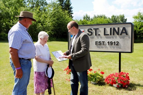 Norbert Dechaine, Eileen Vallee and MP Brian Storseth stand near a newly erected and just unveiled sign in St. Lina on Saturday afternoon. The community previously had no