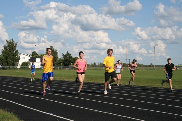 NEAT club members Eric Laramee, Hayley Lucas, Dmitri Krys, Jocelyn Laramee, Courtney Cole and Christian Laramee warm up at a Thursday evening practice for the track club.