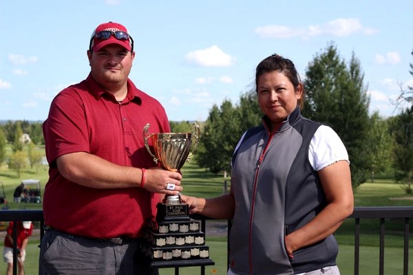 Ryan Yopyk and Jennifer Courterelle, winners of the 2012 St. Paul Golf Club Championship stand with the championship trophy at St Paul Golf Club on Sunday. Yopyk now follows