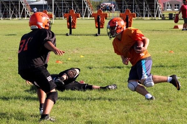 Bengals&#8217; running back Liam Krys carries the ball past teammate Isaac Porozni during a drill at practice last Thursday. The Bengals open their season at home on