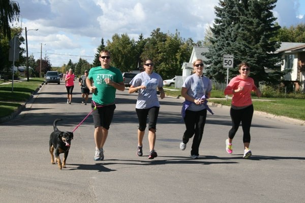 Finnleigh the dog kept pace with Jeremy Yaremchuk, Anita Baudoux, Danielle Burton and Breana Malcolmson as the four runners took part in St. Paul&#8217;s annual Terry Fox Run 