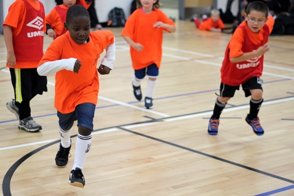 Francis Adebayo chases down the ball during St. Paul Soccer Association&#8217;s first night of futsol at St. Paul Elementary School.