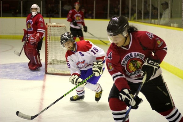 Canadiens captain Rylan Couch battles for the puck against Warriors captain Cole Steinhauer in Saddle Lake on Saturday.