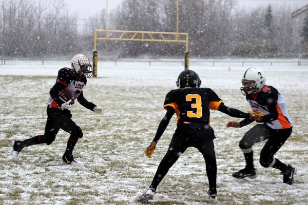 Jason Jubinville moves through the snow while Max Lumby puts on a block during the Lions&#8217; 16-8 loss in Cold Lake against the Royals last Friday afternoon.