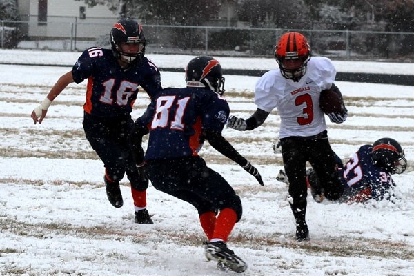 Liam Krys moves the ball down the snowy field in the Bengals&#8217; 39-12 victory over the Lloydminster Chargers on Saturday.