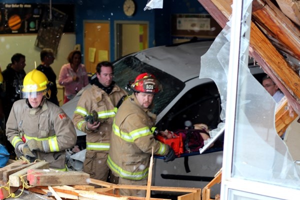 Rescue workers respond to a scene where a vehicle crashed into a Racette School classroom on Thursday morning.