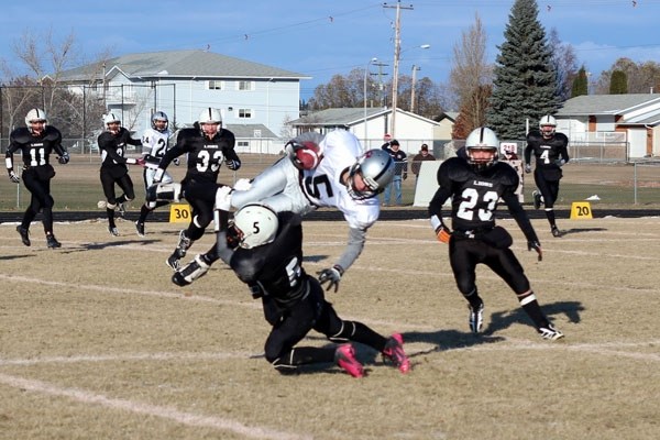 Taylor Joly delivers a massive hit on a Holy Rosary Raider ball carrier during the Lions 61-34 semifinal victory on Saturday.