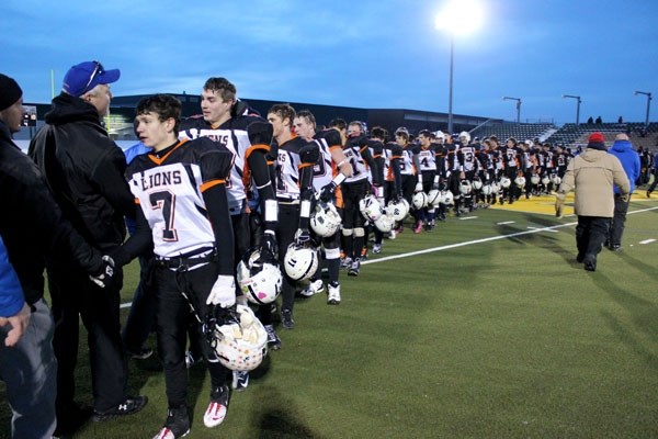 Jason Jubinville (left) and the St. Paul Lions shake hands with the St. Albert Skyhawks after falling 52-10 in the Provincial Tier III Northern Finals on Saturday.