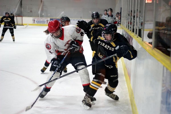 Vegreville Wrangler Hope Probert battles for the puck with Barrhead Pirate Kagen Schmidt during the final of the Bantam A Pink Heart Tournament in St. Paul this weekend.