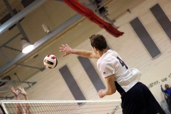 Zachary Upham slams the ball down during the Mallaig Stingers two-set loss against the Acme Redmen in the bronze medal game of the ASAA Provincial Volleyball Championships in 