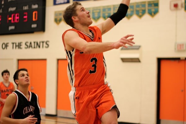 Jeff Hatch lays the ball up during St. Paul&#8217;s 60-54 victory over the Hilltop High Chargers in the final of the Saints Invitational basketball tournament this weekend.