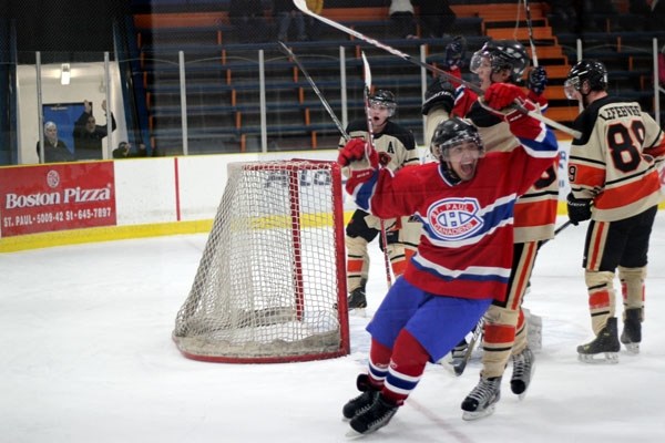 Canadiens forward Skyler Giroux celebrates his 2-1 overtime game-winner against the Wainwright Bisons on Saturday night at Clancy Richard Arena.